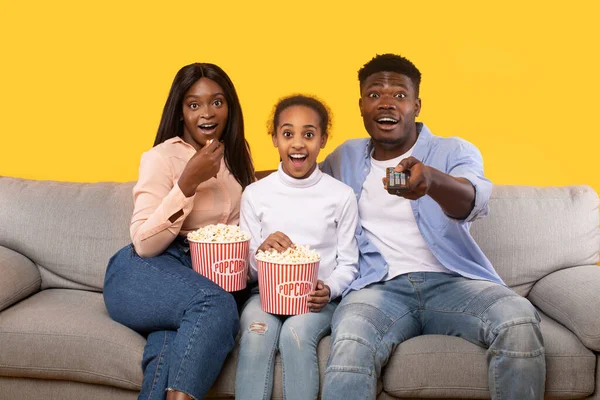 Shocked Black Parents Daughter Watching Movie Eating Popcorn While Sitting — Stock fotografie