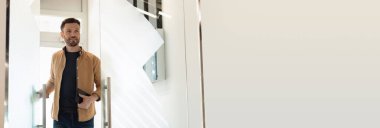 Business Career. Cheerful Businessman Entering His Office Opening Glass Door Holding Digital Tablet Computer Indoors. Looking At Copy Space. Enterpreneurship And Employment. Panorama, Collage
