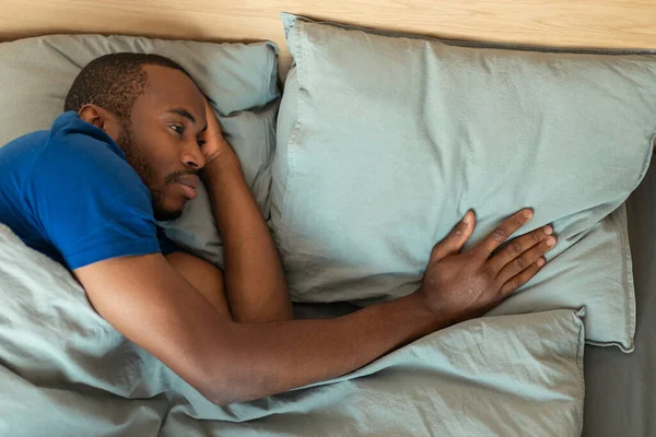 Sad African American Man Touching Pillow Suffering Loneliness Breakup Lying — Fotografia de Stock