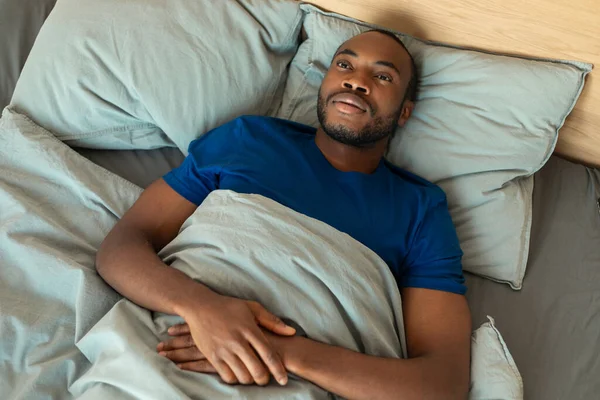 Insomnia Black Man Lying Wide Awake Bed Suffering Sleeplessness Resting — Stok fotoğraf