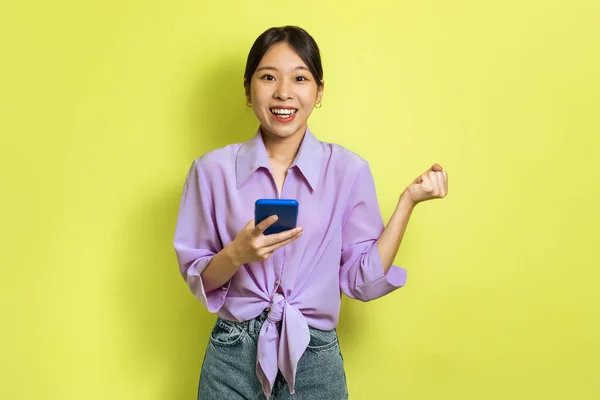 Joyful Asian Lady Using Cellphone Shaking Fists Joy Celebrating Great — Fotografia de Stock
