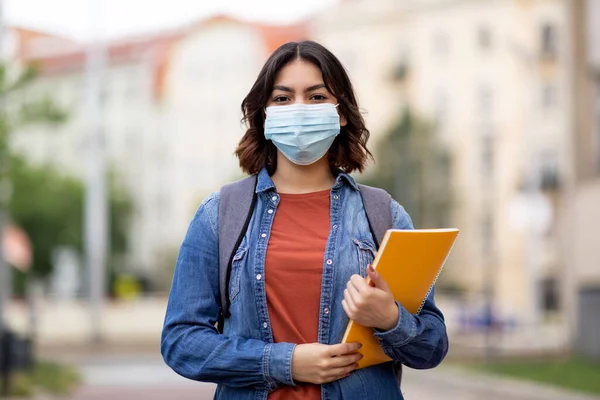 Young Arab Female Student Wearing Medical Face Mask Posing Outdoors — Stockfoto