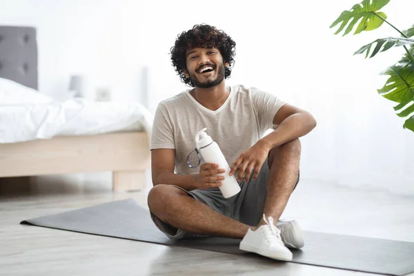 Positive Young Curly Bearded Indian Guy Drinking Water While Having — Foto de Stock