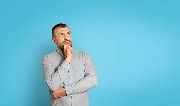 Thoughtful Middle Aged Man Thinking Touching Chin Looking Aside Free — Stockfoto