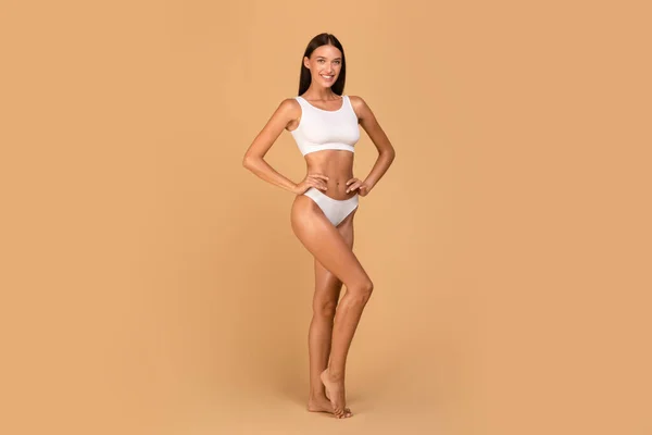Young Slender Caucasian Lady Posing White Underwear Beige Studio Background — Zdjęcie stockowe
