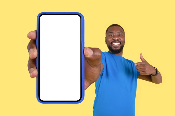 Cheerful Black Guy Showing Big Mobile Phone Pointing Finger Blank — 图库照片