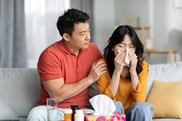 Loving Asian Husband Taking Care Sick Wife Sitting Sofa Next — Photo