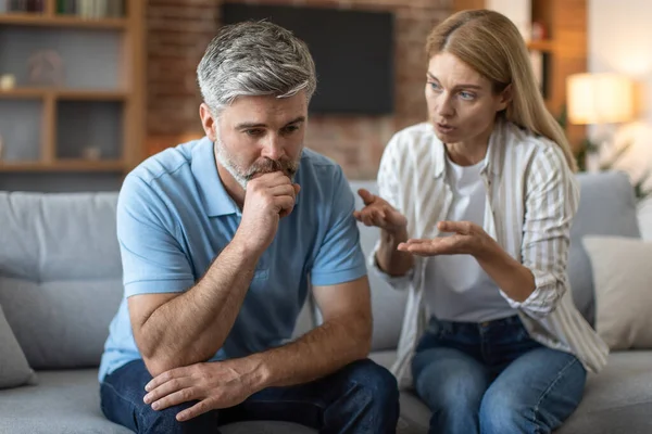 Sad Upset Adult Caucasian Wife Yelling Husband Gesticulates Living Room — Stock fotografie