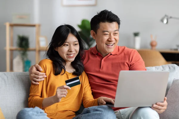 Smiling Asian Man Woman Embracing Using Modern Computer Plastic Credit — 图库照片