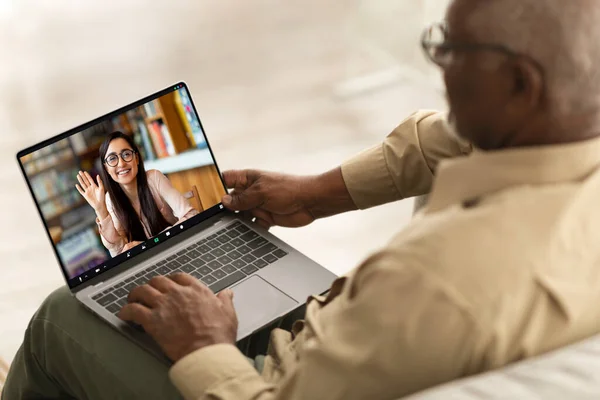 Remote Meeting. Senior Black Man Having Video Call With Young Female On Laptop While Sitting On Couch At Home, Elderly African American Gentleman Using Computer For Web Conference, Creative Collage