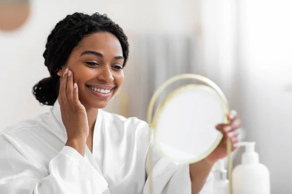 Attractive Young Black Woman Looking Mirror Touching Perfect Skin Face — Stok Foto