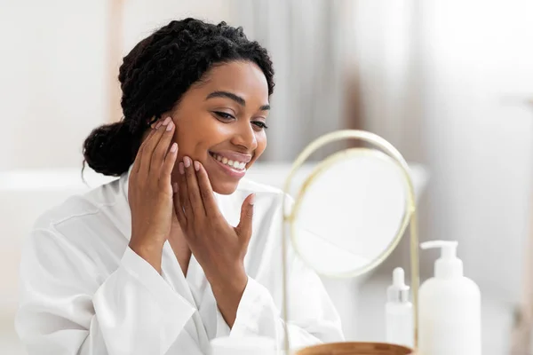 Pretty Black Young Woman Looking Mirror Touching Her Soft Skin — Stok Foto