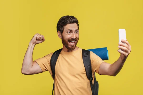 Excited Man Tourist Equipment Taking Selfie Smartphone Yellow Studio Background — Stockfoto