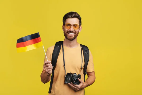 Happy Male Traveler Showing Germany Flag Wearing Backpack Camera Posing — Stockfoto