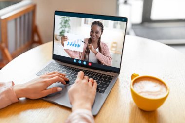 Online Business. Unrecognizable Woman Making Teleconference With Colleague While Sitting In Cafe, Black Coworker Lady Demonstrating Company Financial Graphs And Charts At Web Camera, Collage