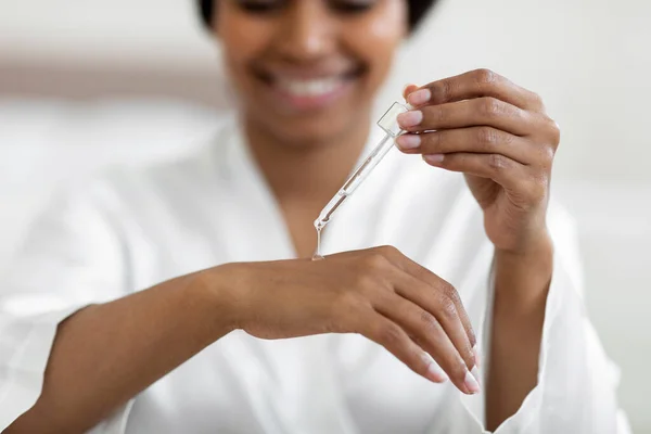 Smiling Black Woman Applying Moisturusing Serum Hand Dropper Closeup Shot —  Fotos de Stock