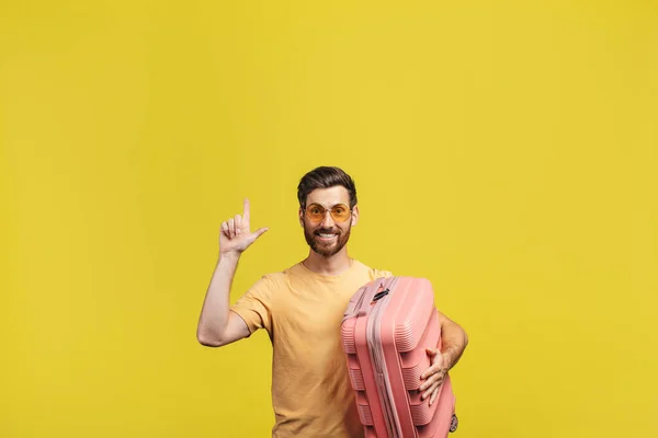 Happy Male Tourist Pointing Finger Copy Space Standing Suitcase Yellow — ストック写真