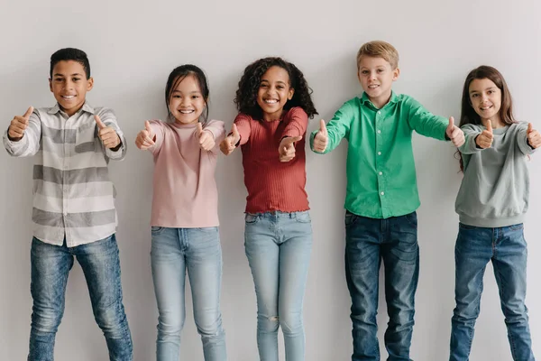 Happy Multiethnic Kids Gesturing Thumbs Approving School Education Offer Posing — Fotografia de Stock