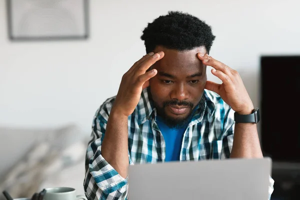 Thoughtful African American Man Using Laptop Computer Working Online Thinking — Zdjęcie stockowe
