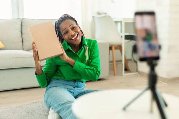 Happy Black Woman Holding Cardboard Box Talking Smartphone Camera Tripod — Photo