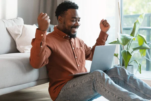 Happy African American Male Freelancer Using Laptop Shaking Fists Joy —  Fotos de Stock