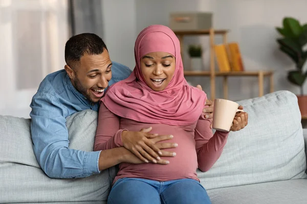 Surprised Pregnant Black Muslim Woman Her Husband Feeling Baby Kicks — Foto de Stock