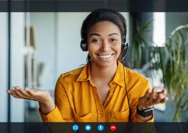 Remote work and technology. Happy entrepreneur wearing headphones while having video conference, talking to webcamera. Videocall interface, app display