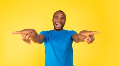 You Are Next. Excited Black Guy Pointing Fingers Choosing You And Showing Direction Smiling To Camera Standing Posing In Studio Over Yellow Background. Choice Concept. Panorama