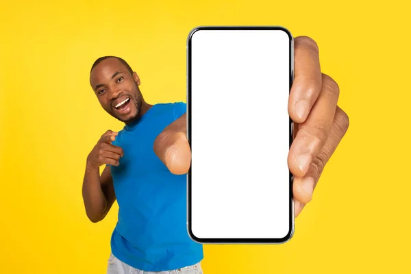 Joyful Black Guy Holding Phone Large Empty Screen Advertising Mobile — Φωτογραφία Αρχείου