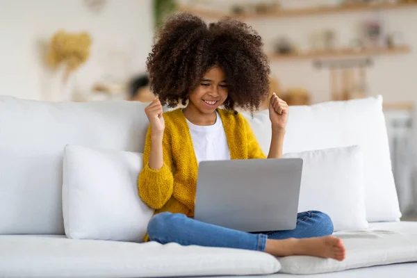 Emotional African American Child Preteen Girl Sitting Couch Home Using — Foto Stock