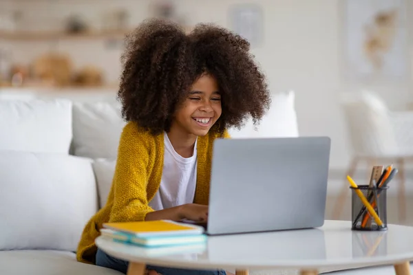 Smiling Adorable Black School Girl Doing Homework Sitting Couch Using — Stock fotografie