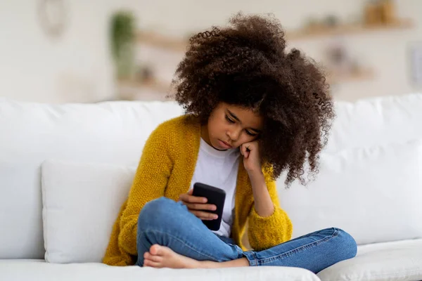 Bored Adorable Curly African American Preteen Girl Sitting Couch Home — Stockfoto