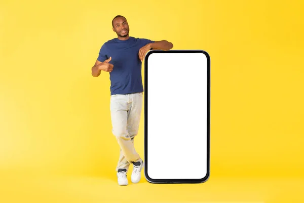 Black Male Standing Huge Mobile Phone Gesturing Thumbs Approving App — 图库照片