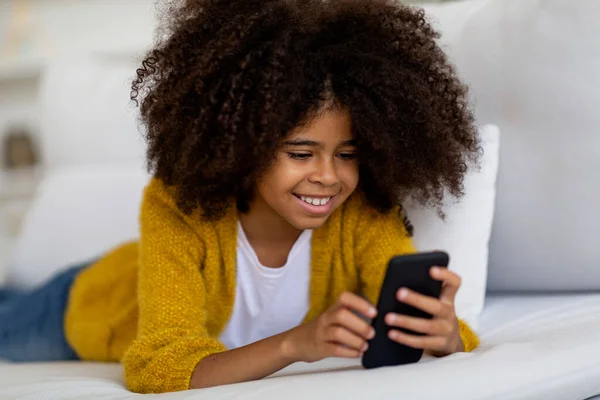 Positive Smiling African American Little Girl Bushy Hair Lying Couch — Foto Stock
