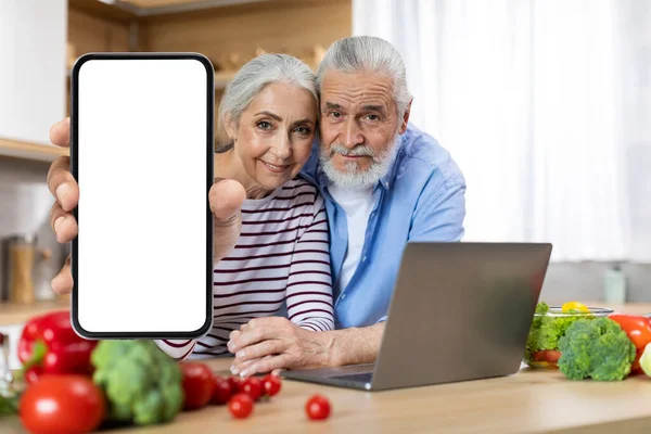 Happy Elderly Couple Showing Big Blank Mobile Phone Camera While — Stok fotoğraf