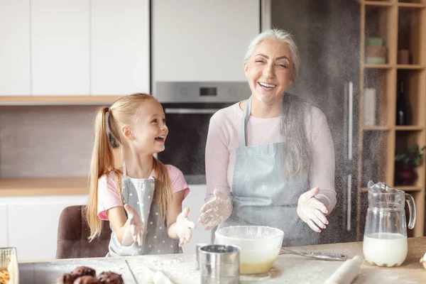 Cheerful Little Girl Senior Grandma Aprons Make Dough Have Fun — Stock fotografie