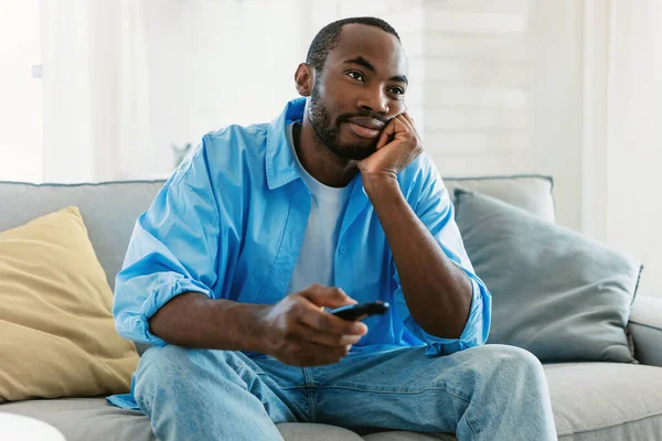 Bored Black Man Watching Boring Switching Channels Holding Remote Controller — Fotografia de Stock