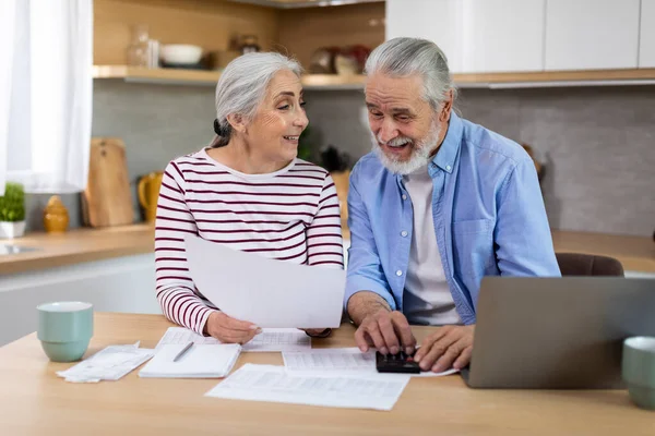 Portrait Cheerful Elderly Spouses Sitting Kitchen Checking Financial Papers Happy —  Fotos de Stock