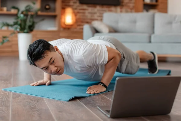 Asian Mature Man Doing Push Ups Looking Laptop Having Online — Stok fotoğraf