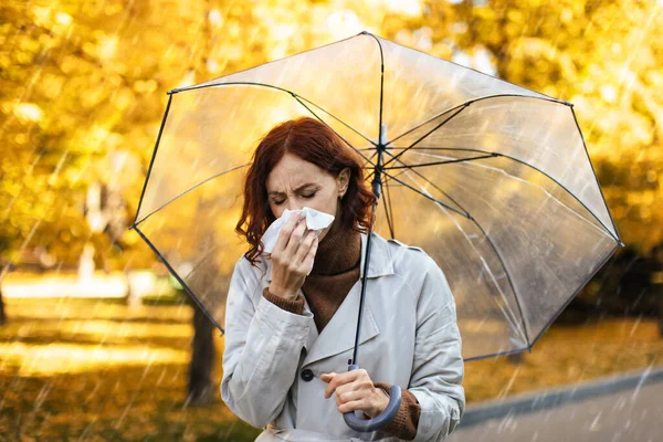 Unhappy Millennial European Woman Raincoat Umbrella Blows Her Nose Napkin — Stockfoto