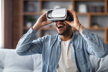 Video Gaming Concept. Portrait Of Amazed Black Man Wearing VR Glasses At Home, Happy Excited Young African American Male Enjoying Virtual Reality Experience With Modern Device, Closeup Shot