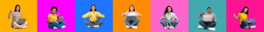 Glad young international ladies sit with laptop, show thumb up, work and study online, isolated on colorful background, studio, panorama. Blogger with approving gesture, chat remotely in social media