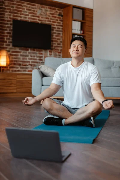 Peaceful Asian Mature Man Meditating Closed Eyes Front Laptop Computer — Zdjęcie stockowe