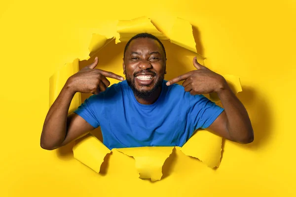 Shot Smiling African American Man Standing Torn Paper Hole Pointing —  Fotos de Stock