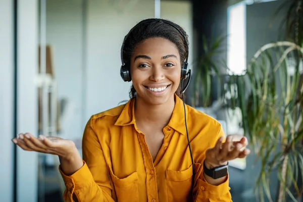 Portrait Happy Black Businesswoman Headset Talking Gesturing Smiling Camera Sitting — Stockfoto
