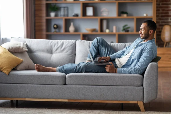 Handsome Black Man Laptop Relaxing Couch Living Room Smiling Young — Foto de Stock