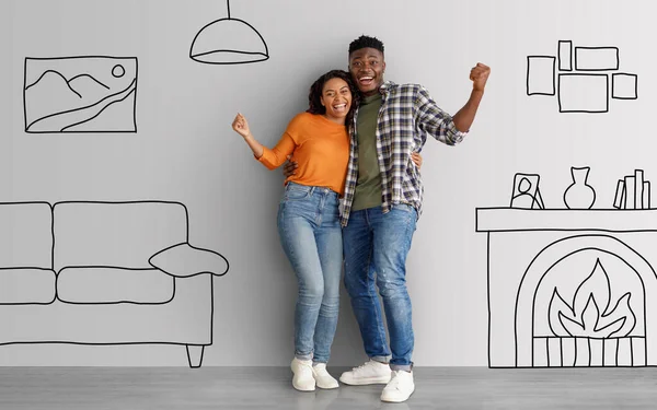 Emotional young black couple posing over interior doodles, happy millennial family celebrating success, hugging and raising hands up, moving to new apartment, collage. Relocation, real estate concept