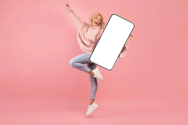 Joyful Young Woman Jumping Big Blank Smartphone Hand Happy Carefree — Foto de Stock