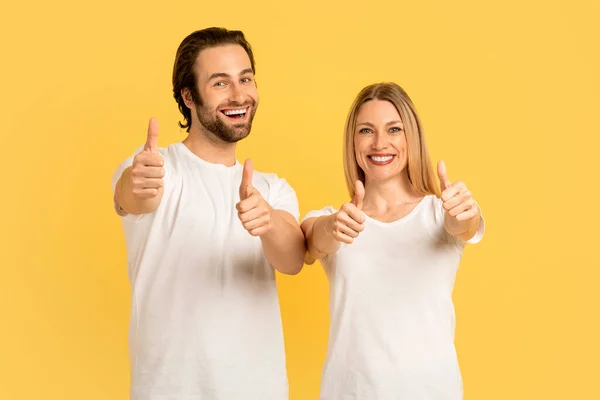 Cheerful Glad Millennial Caucasian Male Female White Shirts Show Thumbs — Photo