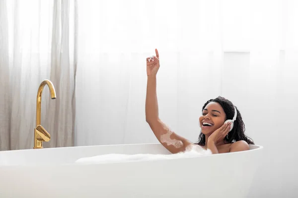 Carefree Young Black Woman Listening Music While Taking Bath Foam — Stockfoto